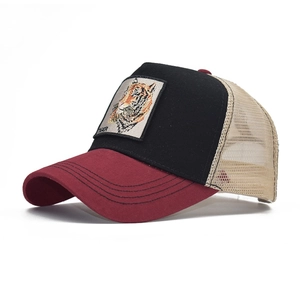 Detail of tiger embroidery patch on a mesh back baseball cap with red visor