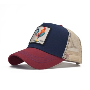 Detail of embroidered rooster patch on tri-color cotton mesh trucker baseball cap