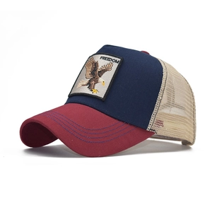 Detail of freedom eagle embroidery patch on navy and red cotton mesh trucker hat