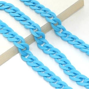 Close-up of bright blue acrylic chunky chain link accessory on a white surface