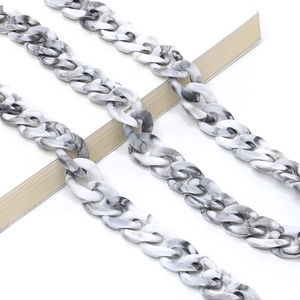 Macro view of marbled acrylic link chain accessory with elegant black and white texture