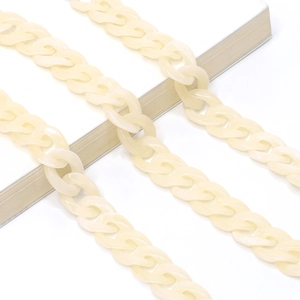 Close-up of cream acrylic link chain with smooth polished finish for fashion accessories