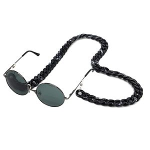 Retro round sunglasses with thick black marble acrylic eyewear chain on white background