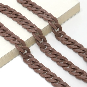 Close-up of brown acrylic chunky chain strap placed on a book for fashion styling
