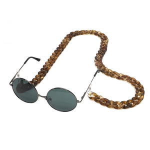 Retro round black sunglasses with a thick amber leopard acrylic chunky eyeglass chain