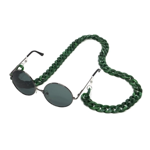 Macro detail of dark green marble acrylic chain link with thin metal frame sunglasses