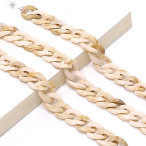 Detail of acrylic eyeglass chain in beige marble pattern with clear rubber connectors