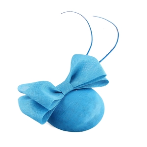 Macro detail of blue fascinator hat featuring mesh bow and elegant feather accents