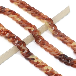 Close-up of thick amber tortoiseshell acrylic eyeglass chain with glossy resin links