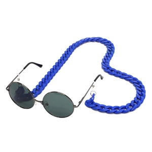 Close-up of vibrant blue acrylic eyeglass chain with vintage round sunglasses