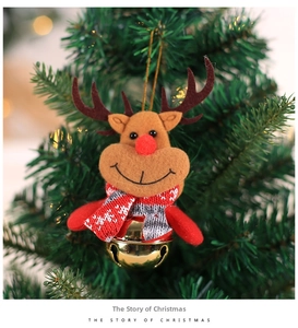 Plush Christmas reindeer ornament with red scarf and gold bell hanging on a green tree