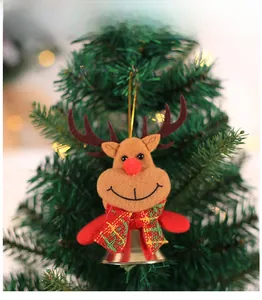 Close-up of a plush reindeer ornament with a golden bell on a Christmas tree branch