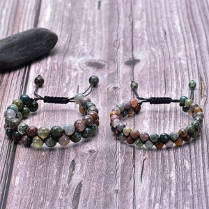 Detail of woven double-layer Indian Agate stone beads with adjustable cord on wood