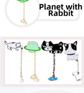 Enamel pin set featuring cartoon cat, dog, and planet designs with hanging charms