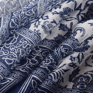 Macro shot of blue and white paisley print on breathable cotton linen scarf fabric