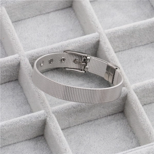 Detail of silver mesh watchband bracelet in a gray velvet jewelry organizer box
