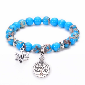 Detail of blue emperor stone beads with silver tree of life and flower pendants