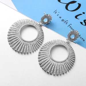 Macro view of silver starburst earrings with white zircon micro-pave setting detail