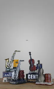Macro view of retro resin saxophone and violin pen holder with musical book details