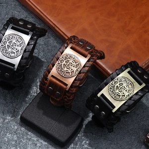 Vintage leather bracelets featuring Celtic knot and pentagram metallic charms on dark stone base
