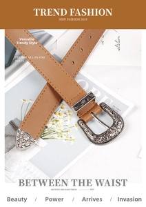 Détail de la boucle gravée en argent et de l'embout en métal sur une ceinture en cuir brun