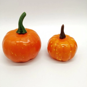 Set of two realistic orange foam pumpkins with yellow speckles on a white background