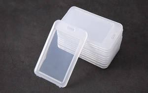 Macro shot of stackable semi-transparent white PVC card holders with top hanging hole