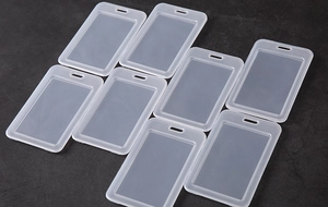 Close-up of translucent vertical ID card holders with clear windows and top lanyards