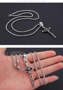 Detailed macro view of silver stainless steel gothic cross necklace with skull accents