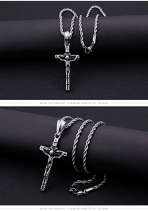 Close-up detail of a silver skull cross pendant on a twist rope chain necklace