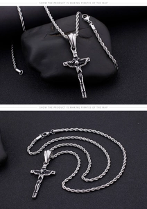 Detailed view of silver skull cross pendant on a rope chain against a dark rock background