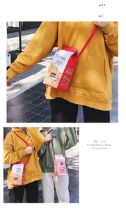 Detail view of creative drink carton shoulder bags in orange and pink milk box designs
