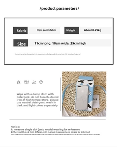 Detail view of milk box crossbody bag in light blue with cow print and size measurements