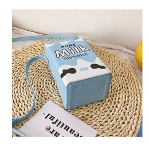 Detail of creative milk carton shaped PU leather shoulder bag with blue and white contrast