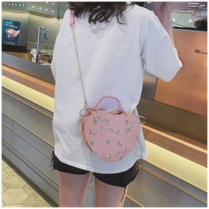 Pink heart-shaped crossbody bag with floral embroidery and chain strap for women