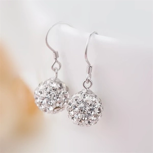 Macro shot of 925 sterling silver ball drop earrings with pavé set sparkling crystals