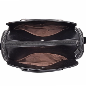Black leather handbag with three large compartments and brown lining shown from top view