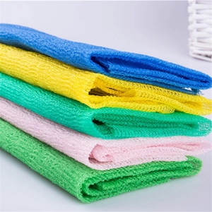 Set of colorful long nylon mesh exfoliating bath towels stacked in five vibrant colors
