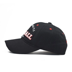 Detail of 3D embroidery on black cotton baseball cap with red eyelets and curved brim