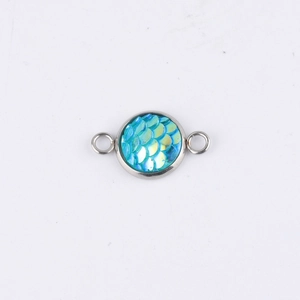 Close-up of a 10mm silver stainless steel pendant with blue iridescent mermaid scales
