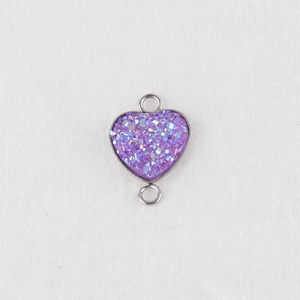 Macro shot of 13mm purple glitter heart pendant with stainless steel frame for DIY jewelry