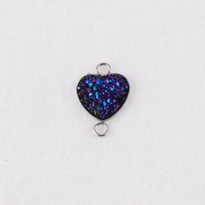 Detail of a 13mm heart-shaped connector in blue-purple gradient glitter with metal border