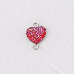 Close-up of red heart stainless steel connector with sparkling glitter for jewelry DIY