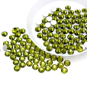 Close-up of olive green glass flatback rhinestones for DIY nail art and decoration