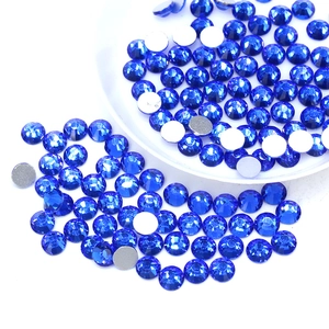 Macro shot of blue flatback rhinestones in white tray showing silver plating and facets