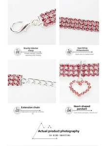 Detailed view of pink rhinestone pet collar with heart pendant and lobster clasp