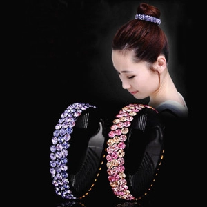 Detail of expandable bird nest hair clip with three rows of purple and pink rhinestones