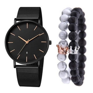 Detail view of black mesh watch with calendar and beaded bracelets with crown charms