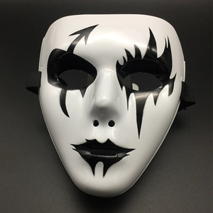 Detail view of a white Halloween mask with black hand-painted artistic patterns and straps