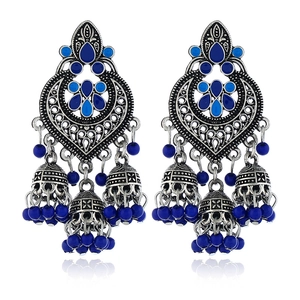 Detailed view of silver Jhumka earrings with blue enamel hearts and hanging beads